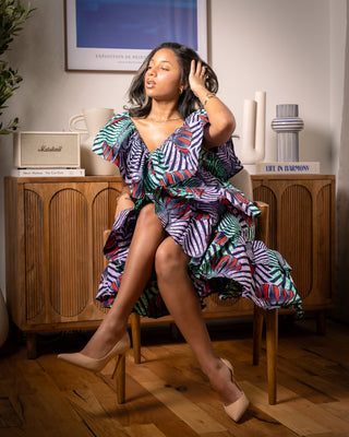 African print wrap dress woman sitting on chair